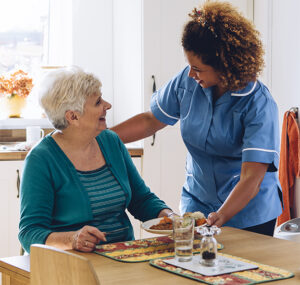 caregiver serving a resident their meal